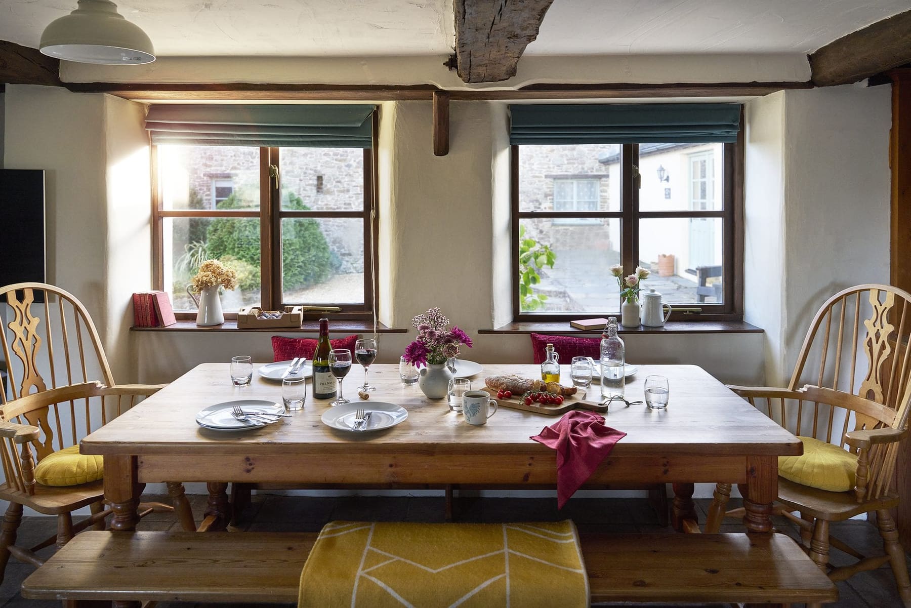 Jasmine Cottage dining table set beneath the windows