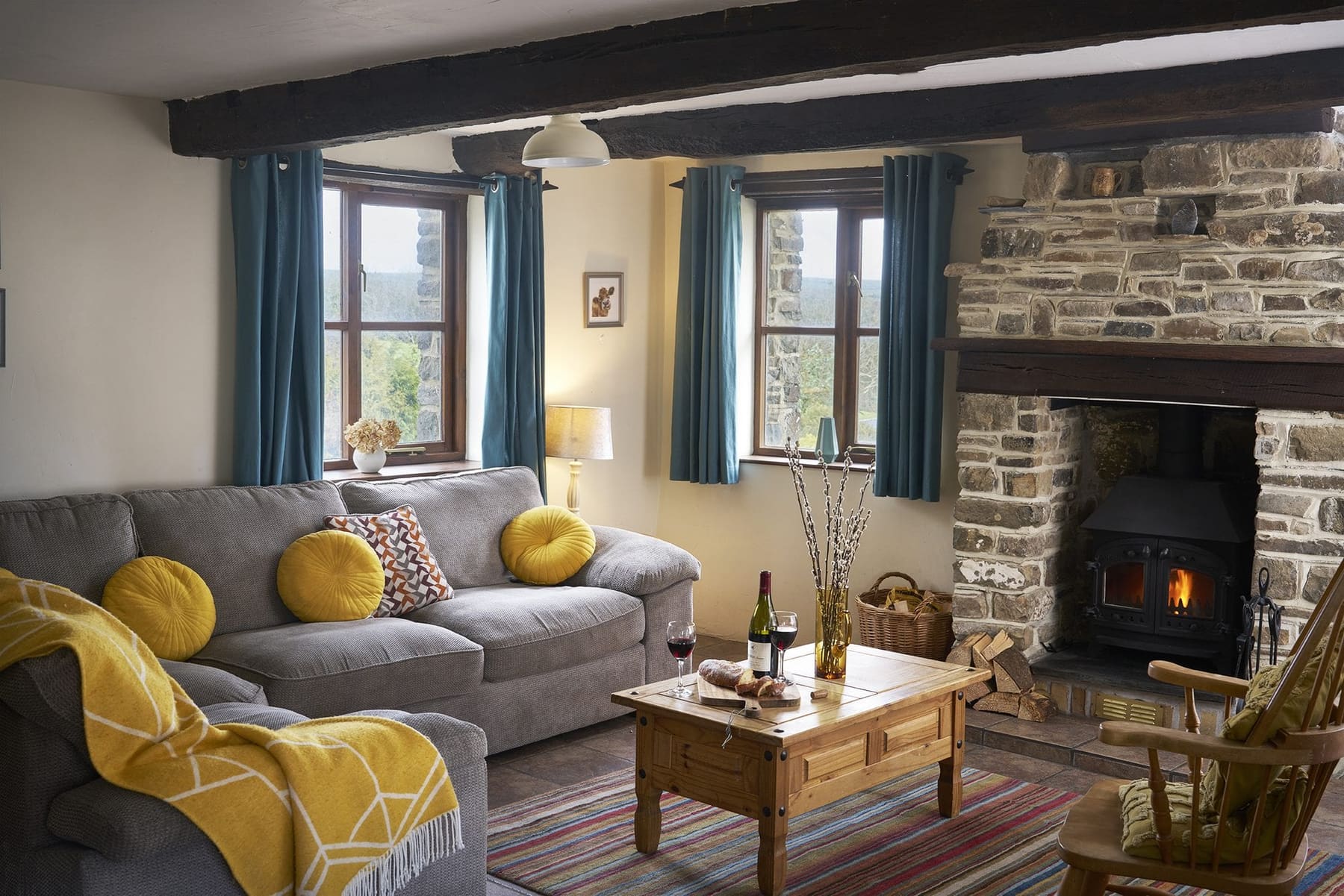 Jasmine Cottage lounge with wood burner and grey sofa