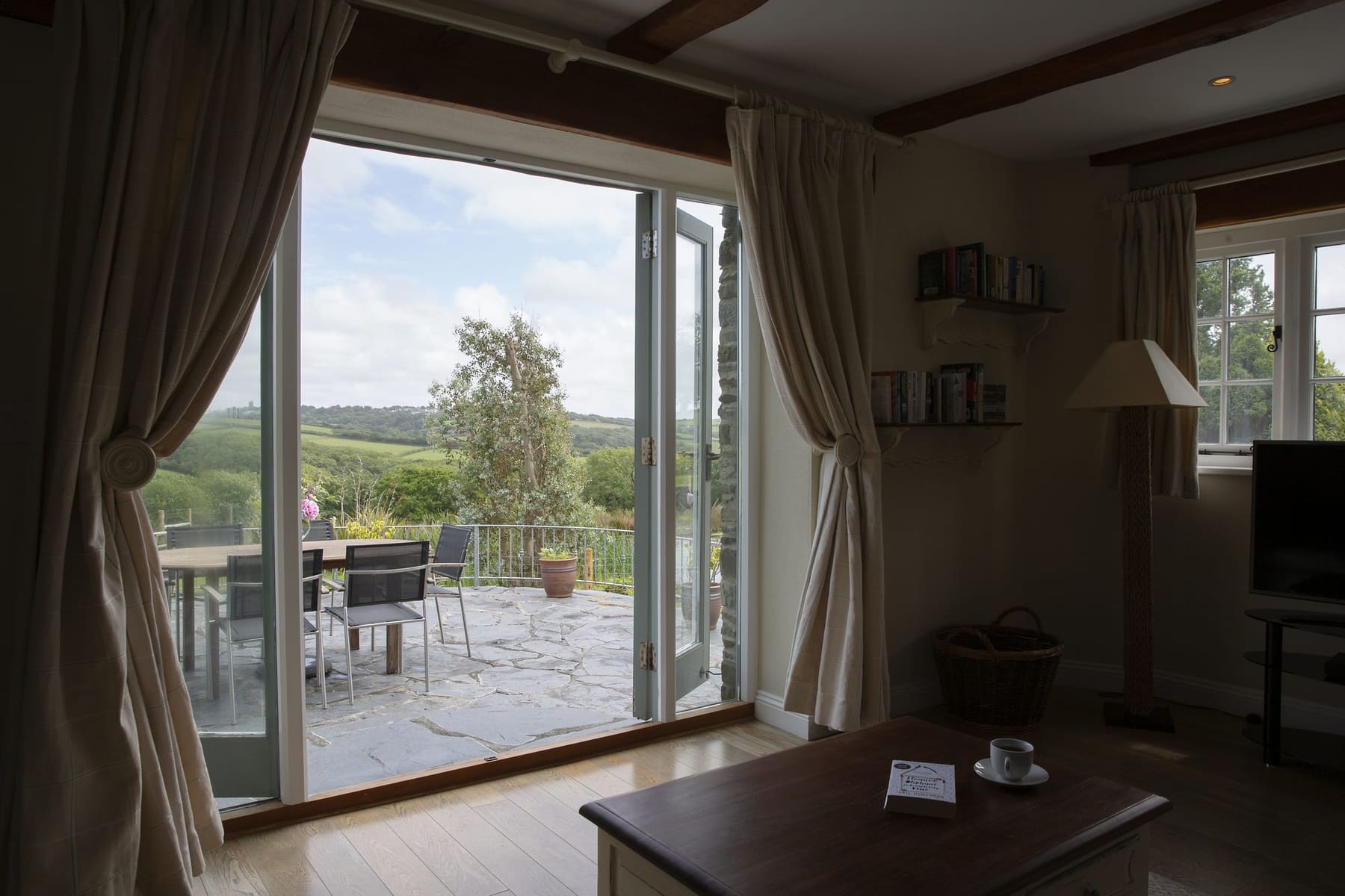 The Stables lounge with French doors opening onto the valley view