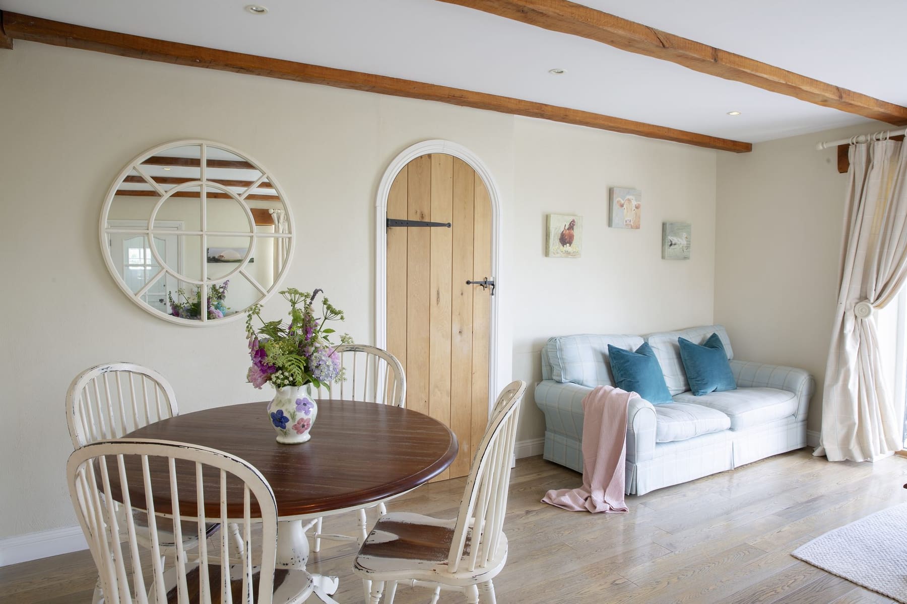 The Stables lounge with arched door and sofa