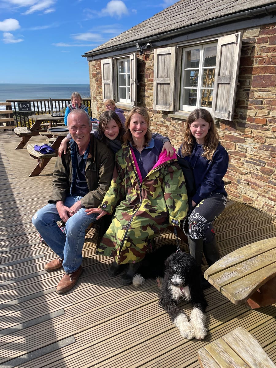 Andy and Ruth Peters with their daughters and Bailey the dog on the Cornish coast