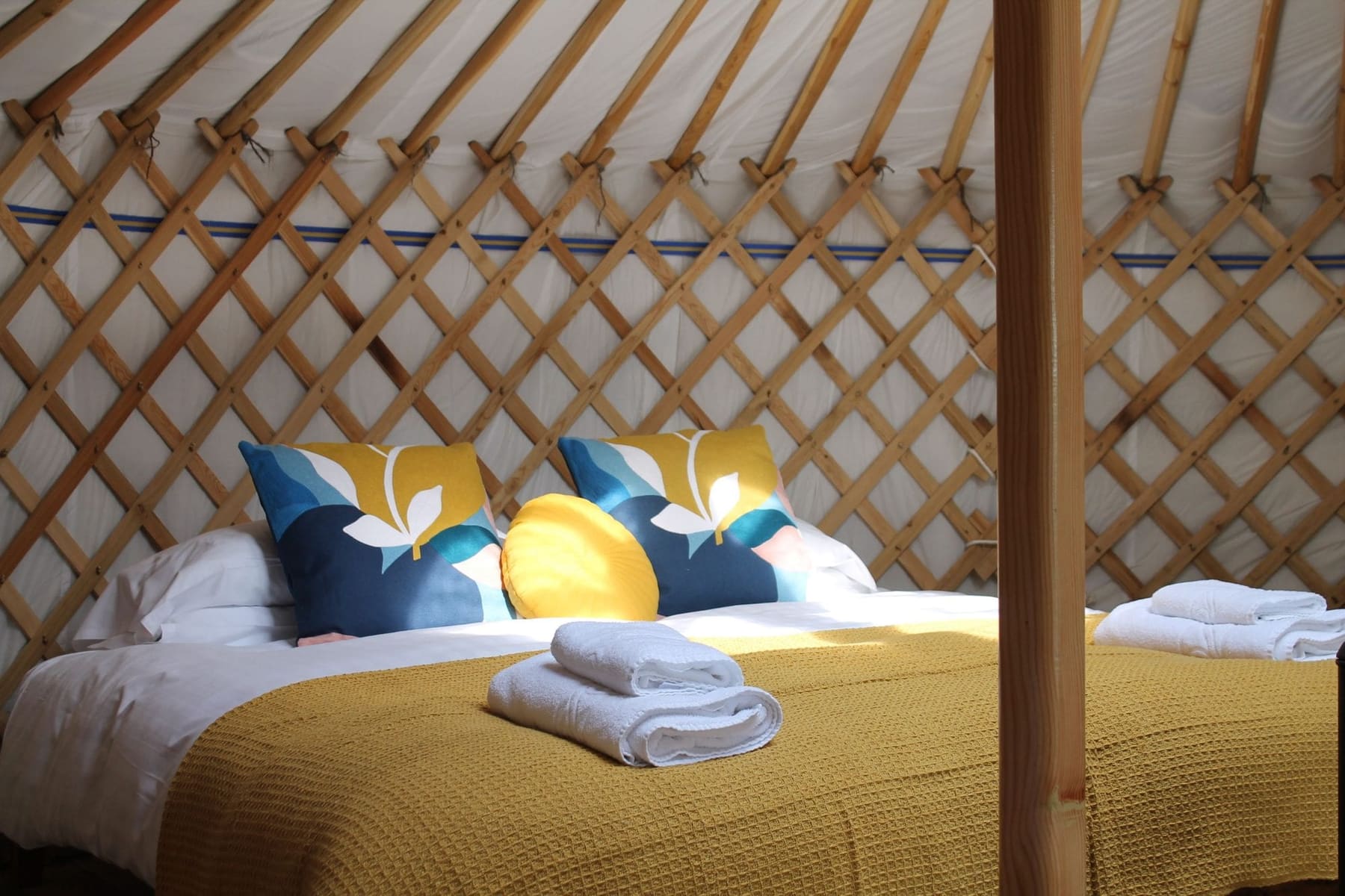 Budhyn yurt super-king bed made up with luxury linen and cushions