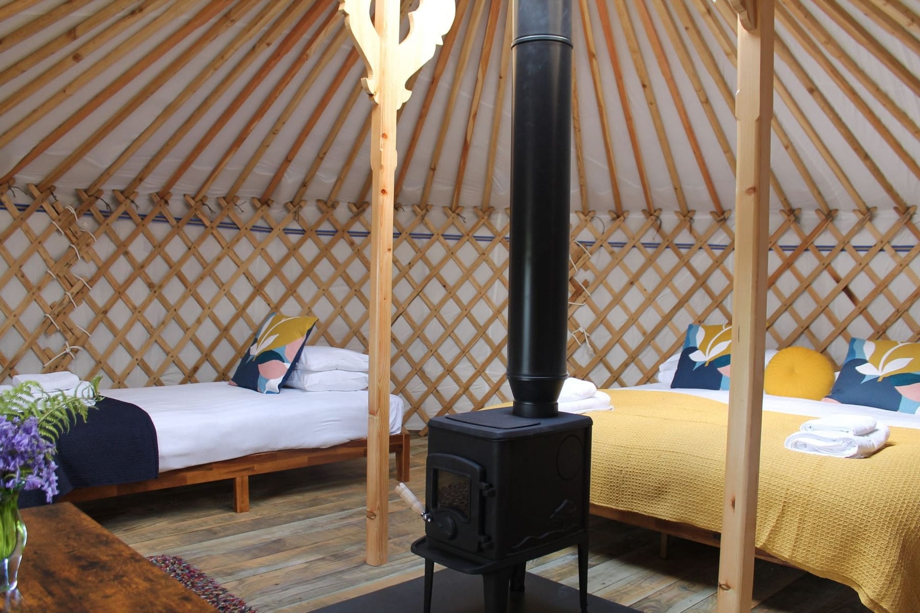 Budhyn yurt interior from the side, wood burner and beds