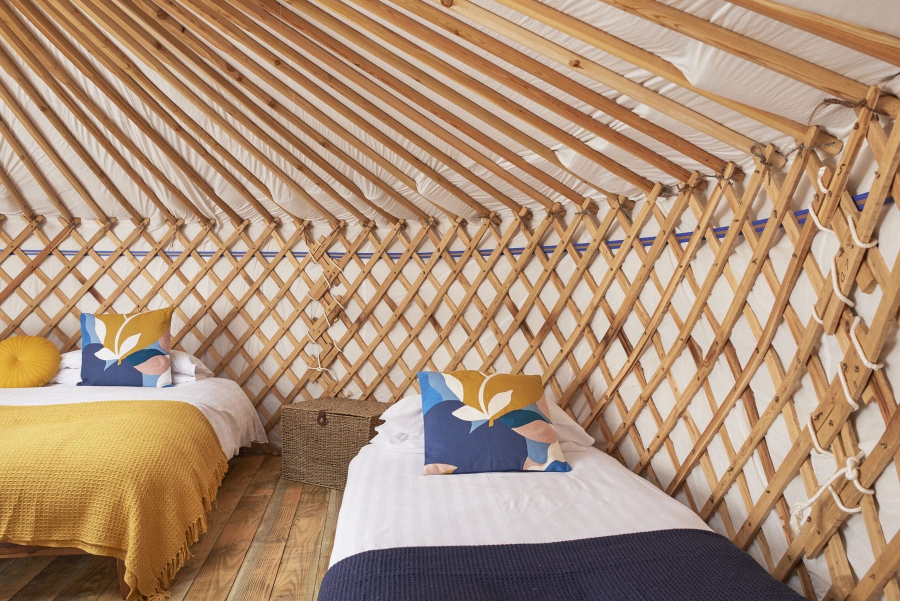 Two single beds against the yurt lattice at Budhyn