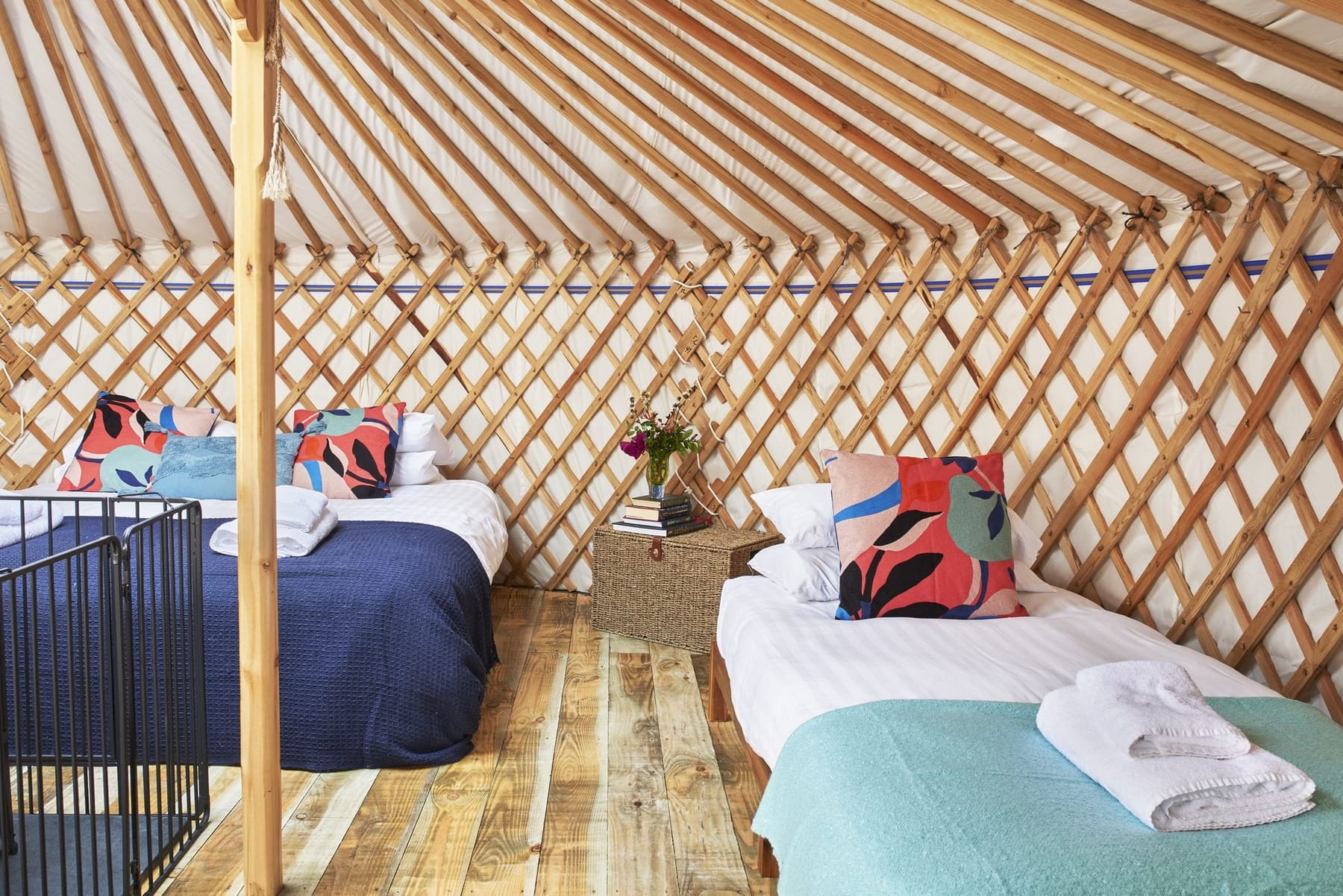 Fenton yurt interior from the side, wood burner and beds