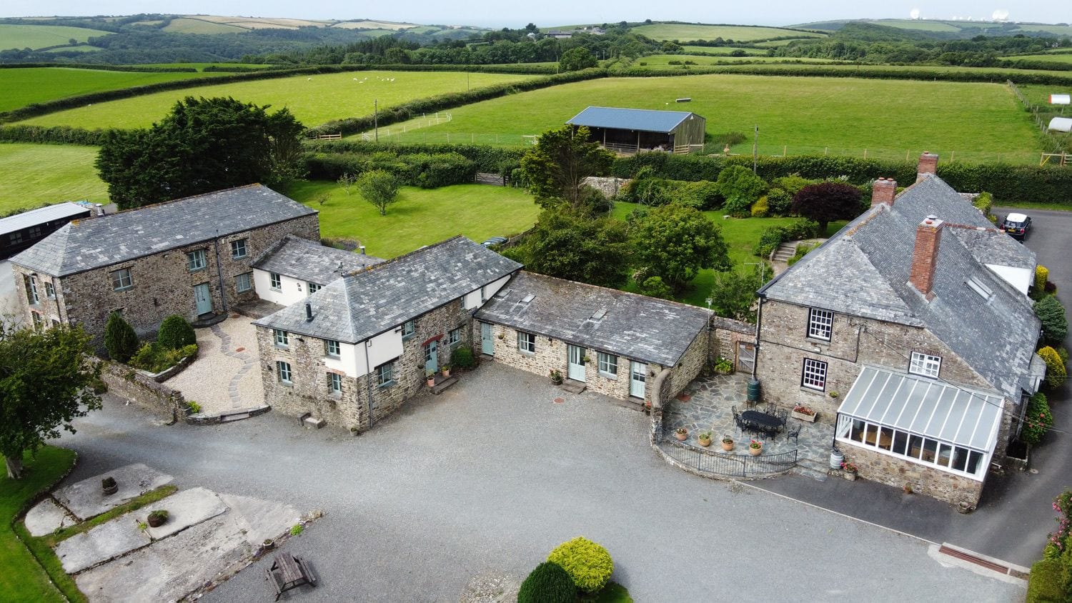 Aerial view of the cottages surrounded by Cornish countryside