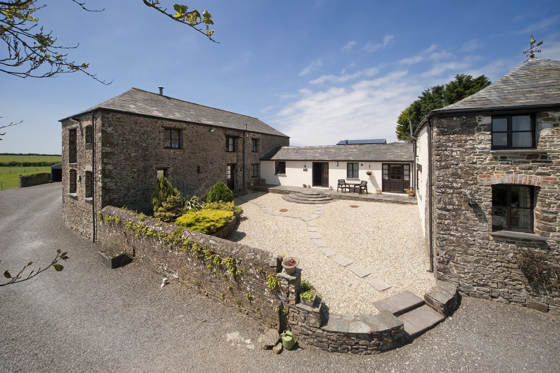 Honeysuckle Cottage exterior, stone barn conversion in the courtyard at Woodlands Manor Farm, Bude