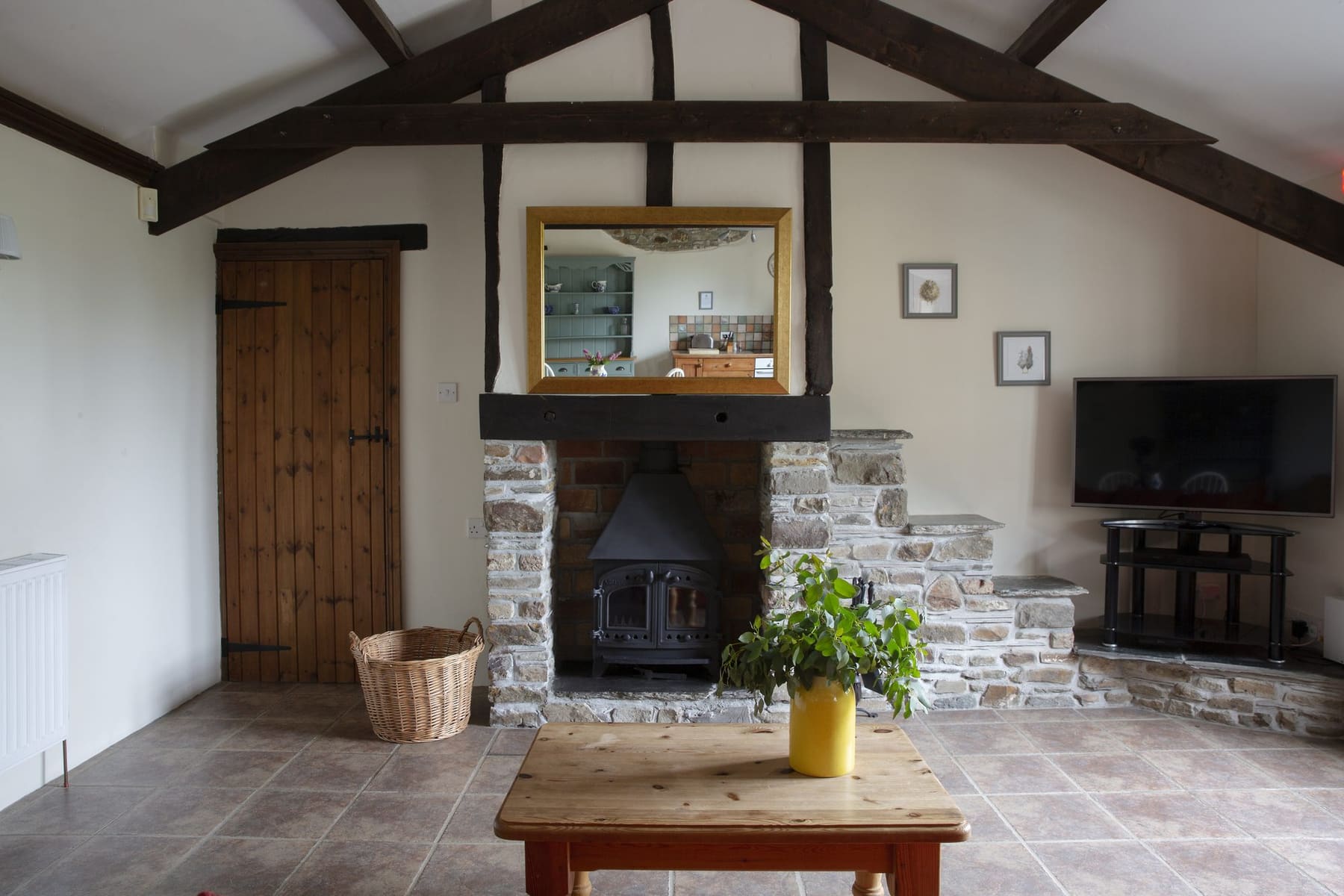 Honeysuckle Cottage stone fireplace with wood burner