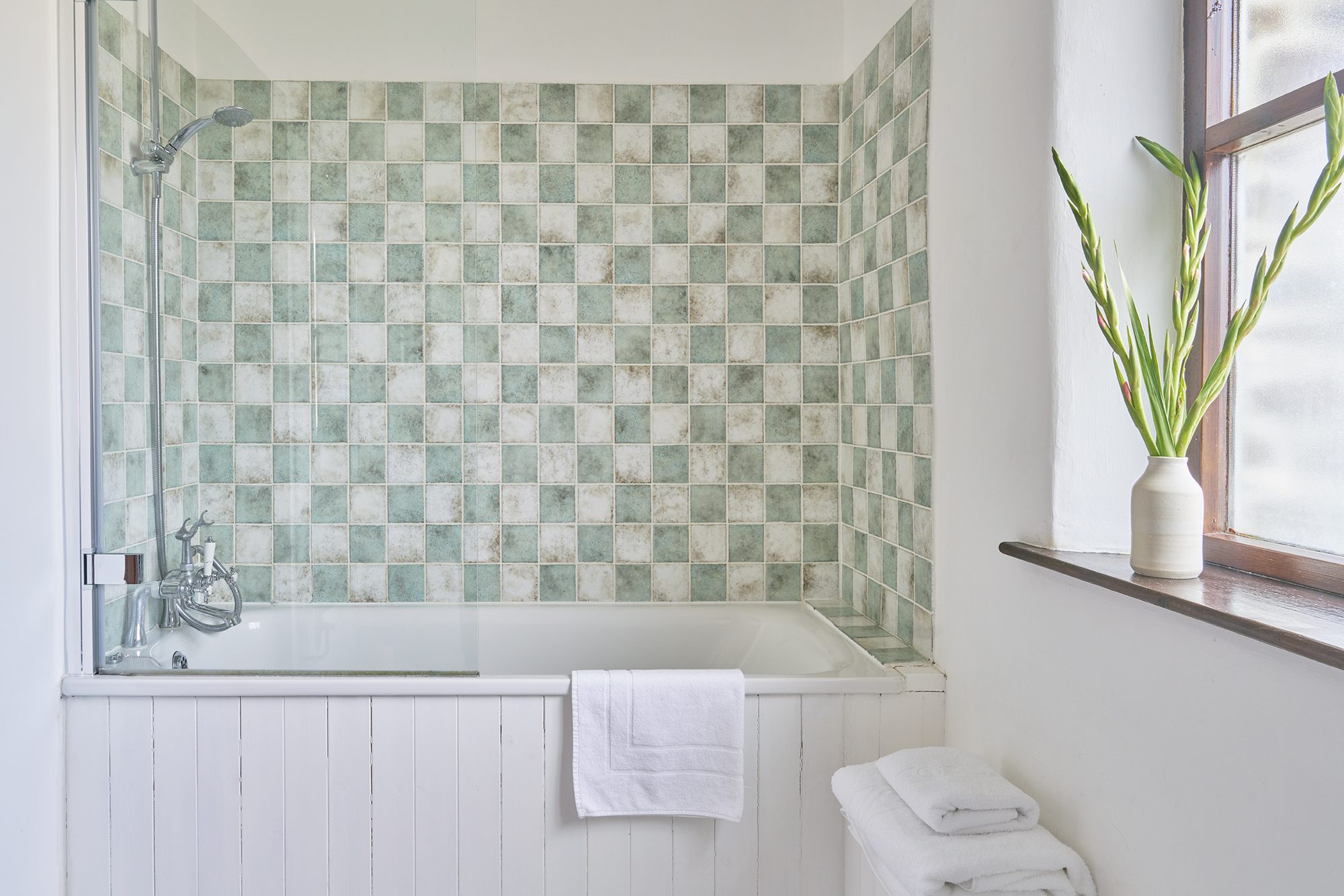 Rose Cottage bathroom with bath and green tiling