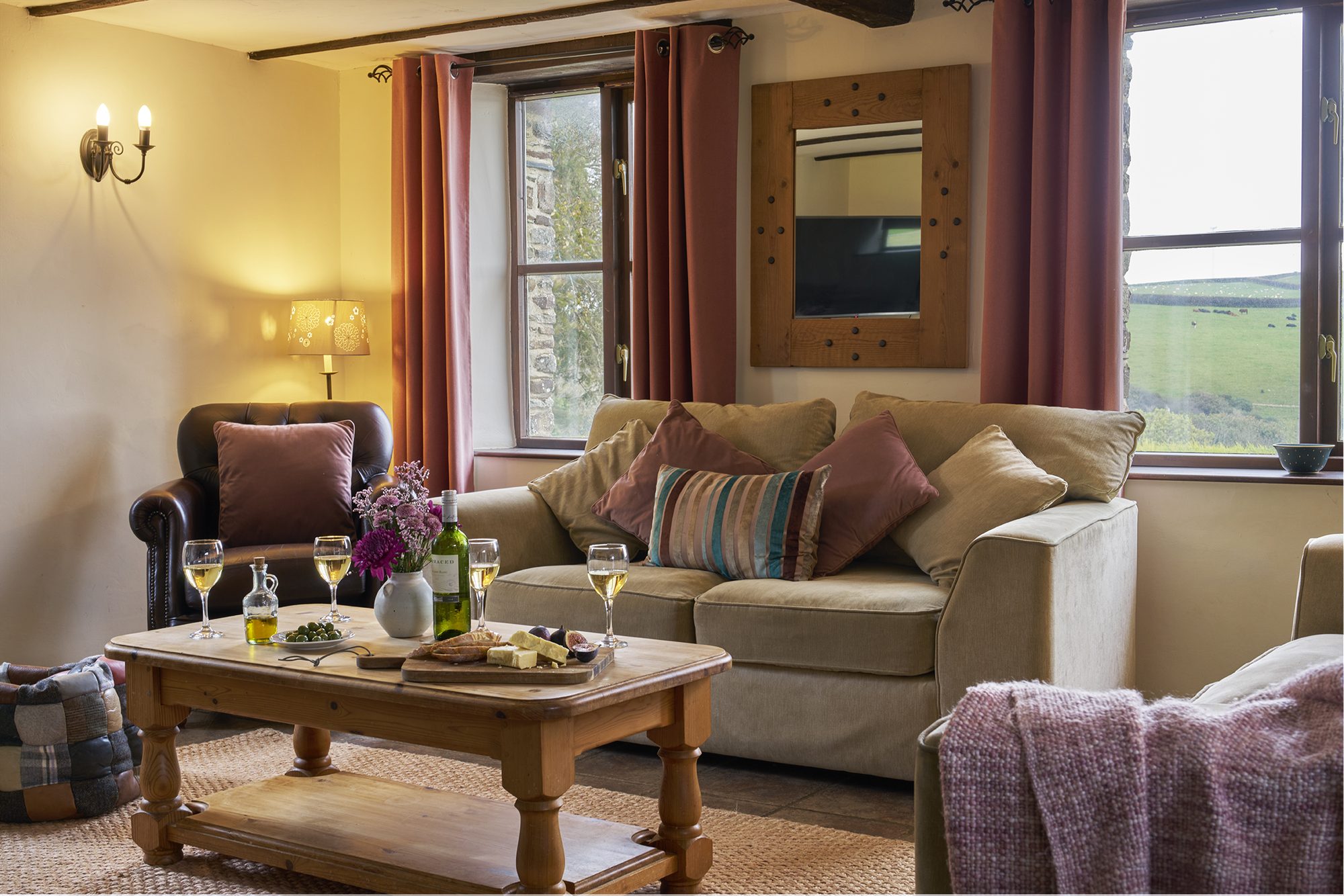 Cosy second lounge at Rose Cottage with wood burner and sofas