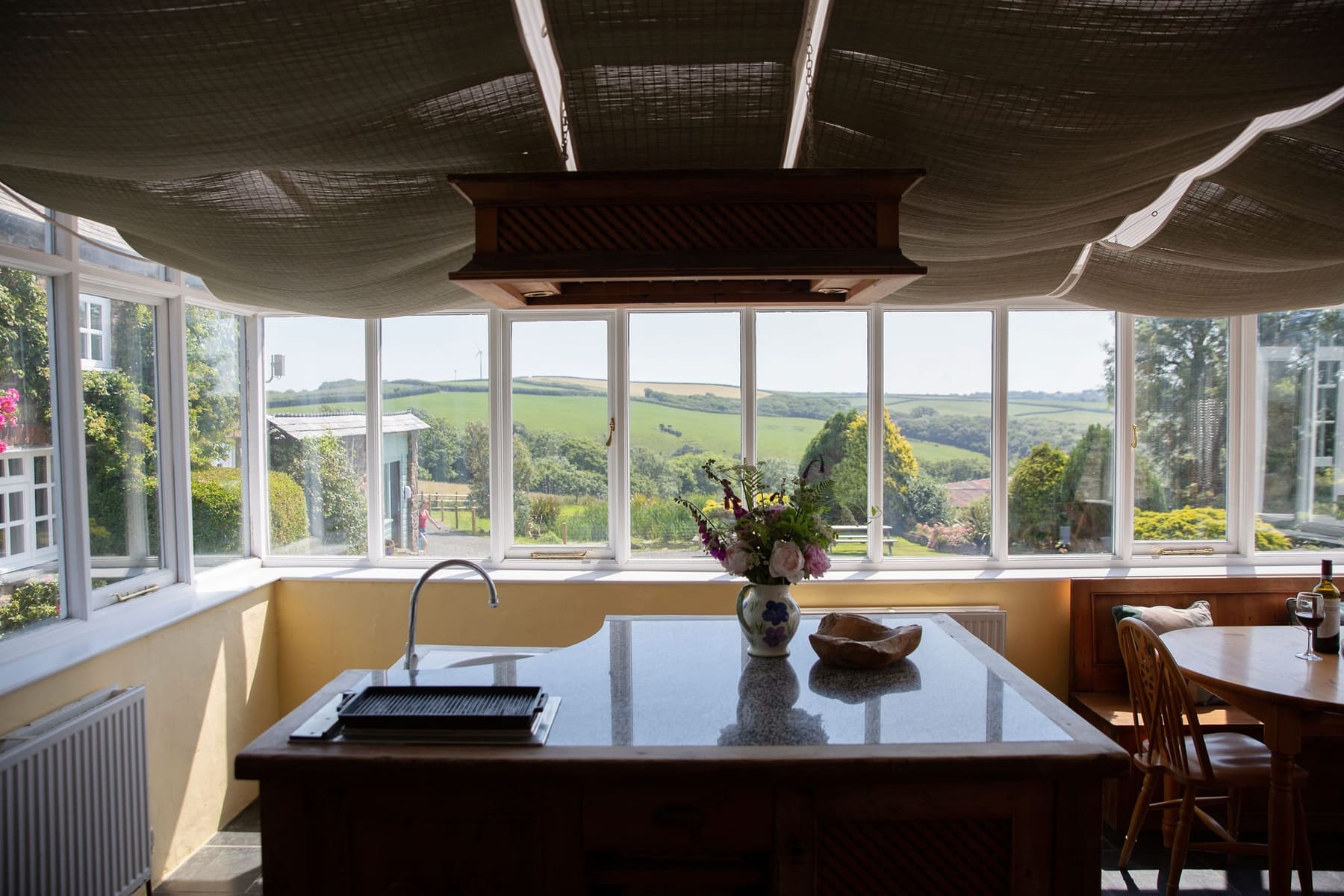Conservatory kitchen island looking out over the Coombe Valley