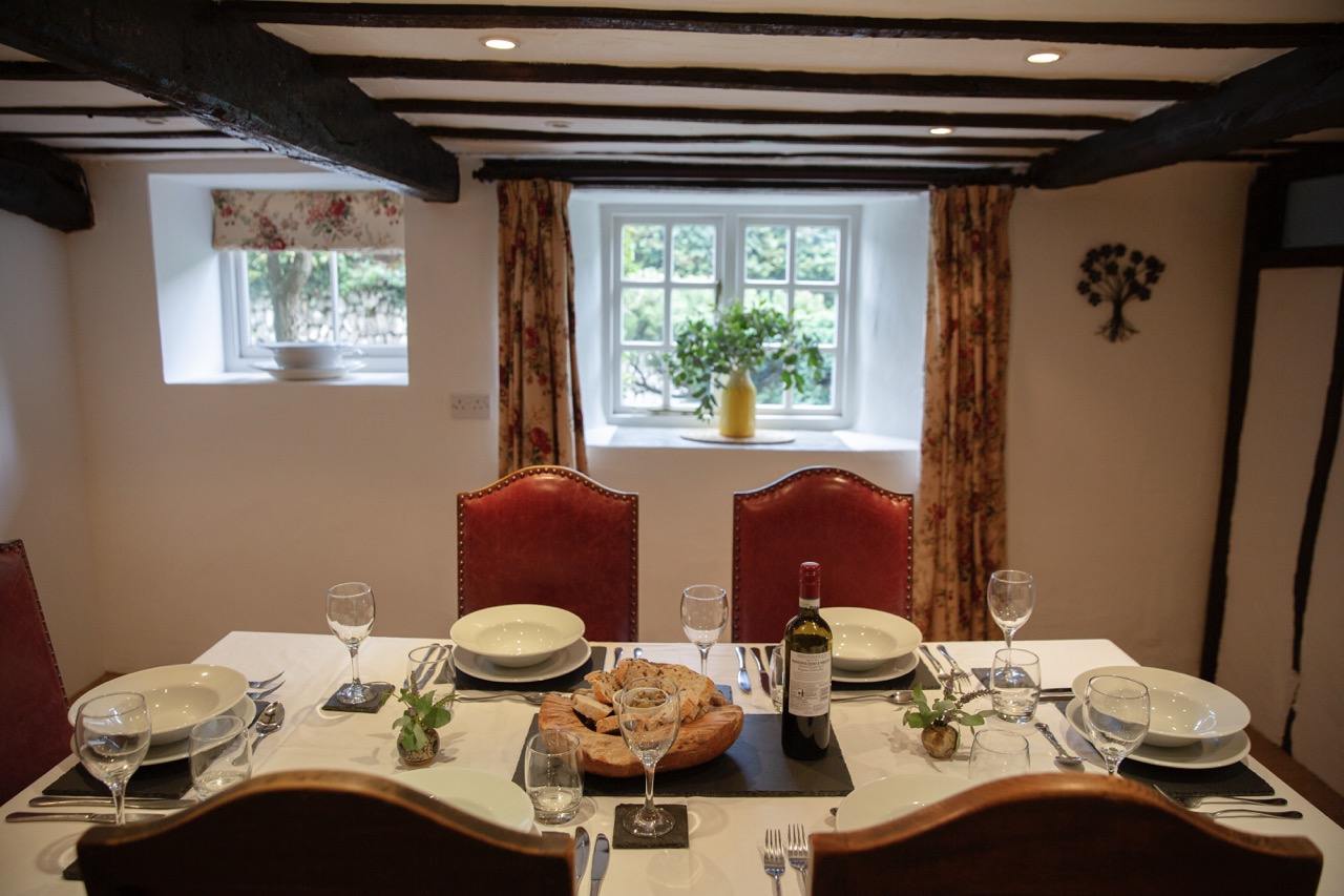 A dining table set for a meal at Woodlands Manor Farm